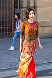 Printed Ao dai in front, Western outfit in the background.