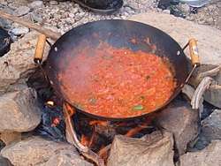 Galayet bandora cooked over a campfire in Wadi Mukheiris, near the Jordanian coast of the Dead Sea.
