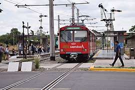 Red tram at a station