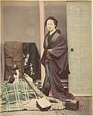 Japanese Woman in Traditional Dress Posing with Cat and Instrument ca. 1870s.