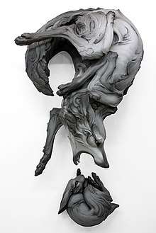 Title: "The Question That Devours"  Year: 2012 Dimensions: H 64 x W 35 x D 25 in. Materials: Stoneware, paint Installation: Wall Piece