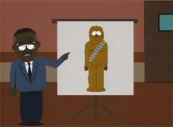 In this scene from the television series South Park, Johnnie Cochran stands in a courtroom next to a large screen on a tripod. He points to a picture on the screen of Chewbacca, who is wide-eyed and standing stiffly.