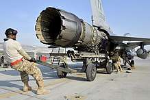 View of a jet engine being pulled out of an F-16