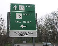 A sign stating Route 15 south to New Haven to the left. It also states Route 15 north is straight ahead. It says "No Commercial Vehicles"
