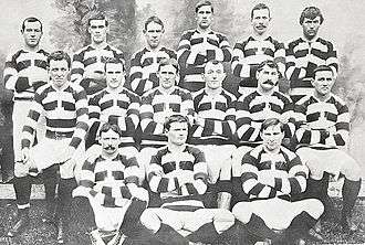 Photo of a group of rugby players posing in their uniforms