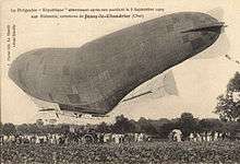 An damaged semi-rigid airship sags under the weight of its gondola.