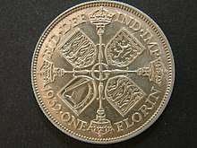 One side of a 1932-dated silver coin, with an arrangement of crowns and sceptres