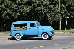 A 1953 blue Canopy Express from Chevrolet, loaded with fruits and veg.