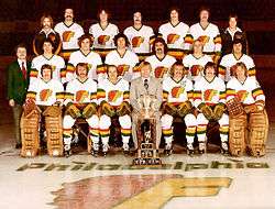 Coach Gregg Pilling in the middle of the front row, with the 1976–77 Philadelphia Firebirds team photo, and the 1976 Lockhart Cup.