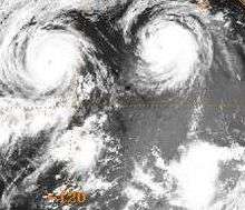 A satellite image displaying three tropical cyclones on July 25, 1990