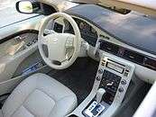 Top down view of V70 drivers area with beige interior and glossy wood trim