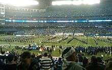 University of Connecticut marching band on the Rogers Centre field, in a formation spelling out U C O N N