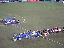 Aston Villa and Chelsea players line up on the pitch ahead of the 2011 final.