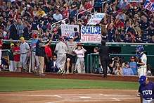Baseball fans near the dugout hold signs saying "Capitol police MVP" and "Scalise Strong".