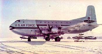 A large four-engined transport aircraft sitting on the ground