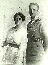 Half-length portrait of man in military uniform beside woman wearing white dress