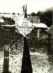 Crucifix, made from an aeroplane propeller, in a cemetery. The inscription reads "Lt. Col. R.S. Dallas DSO DSC&nbsp;...&nbsp;Killed in Action"
