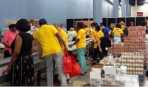 AARP volunteers packing food for older Americans in need at packing event in Miami.