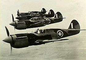 Four single-engined military monoplanes in flight