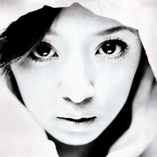 A black-and-white up-close shot of Ayumi Hamasaki's face looking into the camera.
