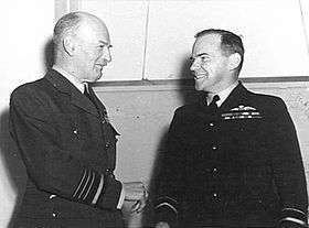 Informal half portrait of two smiling men in dark military uniforms