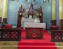 Church altar, with red carpet and flowers