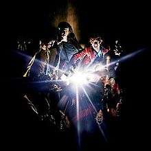 A painting of the band members with an explosion of light in the center