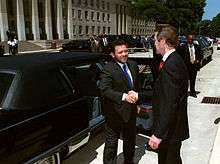 Abdullah shaking hands with former US defense secretary William Cohen outside a limousine