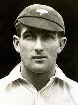 A headshot of a cricketer in a cap