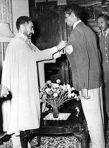  Haile Selassie awards the Star of Ethiopia to Abebe Bikila in the Green Salon of the emperor's palace.