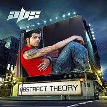 An image of a man wearing a red sleeveless shirt and blue jeans is shown on a building. The album title is placed below it on a billboard and the artist's logo is on the upper left corner of the cover.
