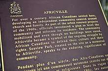 Text reads "For over a century African Canadians settled here, developing an independent community centred around church and family. As part of the urban renewal projects of the 1960s, officials introduced a plan to level the community and relocate its residents. The community mobilized and even though no buildings were saved, Africville became a smybol of the ongoing struggle by African Canadians to defend their culture and their rights. Seaview Park, created on the site as a memorial to Africville, speaks to the enduring significance of community."