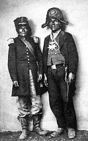 A black and white photograph of two Native Americans wearing military-style uniforms