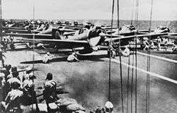 Aircraft lined up on the deck of an aircraft carrier