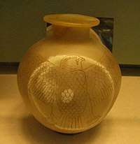 A yellow spherical jar inscribed with a falcon wrapping around the circumference.
