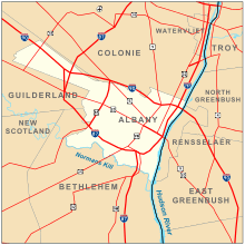 A map of Albany, highlighted in yellow on an orange background. The Hudson River is a blue meandering line down the middle. Interstate highways and major roads are represented by red lines