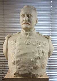 Sculpture of a young man wearing a military uniform with a prominent moustache