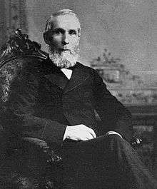 Monochrome photograph of Alexander Mackenzie sitting in a chair
