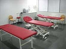 Massage room with three red massage tables