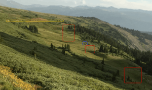 This annotated view shows the damage to the alpine tundra caused by illegal offroading on Rollins Pass. The vehicle is outlined in blue, the tire tracks in red, and the designated road in yellow.