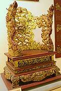 Ornate gold-and-wood throne-shaped altar
