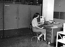 Programmer, Irma Lewis, at the console of the Alwac III computer, 1959.