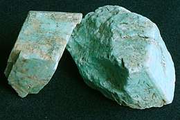 Photo of a turquoise mineral with beige microcline speckled within it