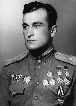 1945 postwar portrait of Amet-khan Sultan in uniform, wearing his two hero of the Soviet Union medals, three orders of Lenin and three orders of the red banner on one side of his chest (right side in photo, left in life) and his Order of the Red Star, Order of the Patriotic War, and Order of Aleksander Nevsky on the other side.