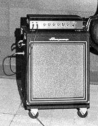 A 1950s era amplifier unit sitting on top of a bass speaker cabinet.