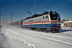 Silver, red, white, and blue locomotive in the snow