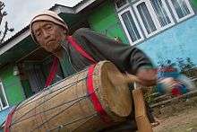 An aged man playing Chyabrung Drum, Yuksom, West Sikkim, India