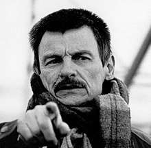 Monochrome photo of Andrei Tarkovsky pointing towards the camera that took the picture