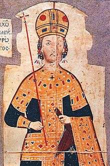 Upper torso of a young bearded man. He wears a golden domed crown and is dressed in a long black, heavily gold-embroidered robe. One hand holds a scepter; the other, an akakia.