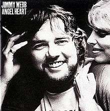 Album cover image of Jimmy Webb with a beard holding a cigarette, with a woman leaning in